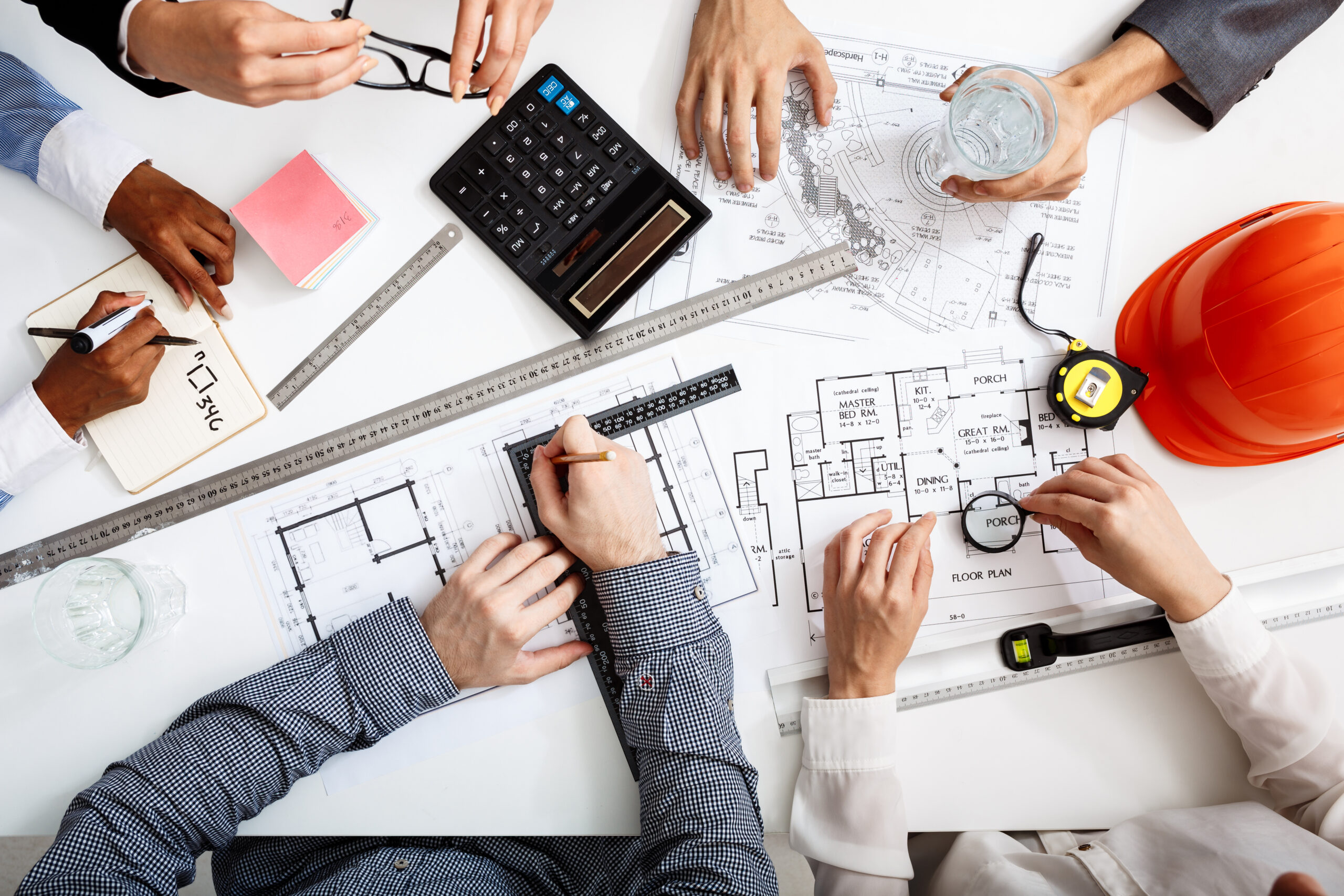 Picture of businessmen's hands on white table with documents and drafts