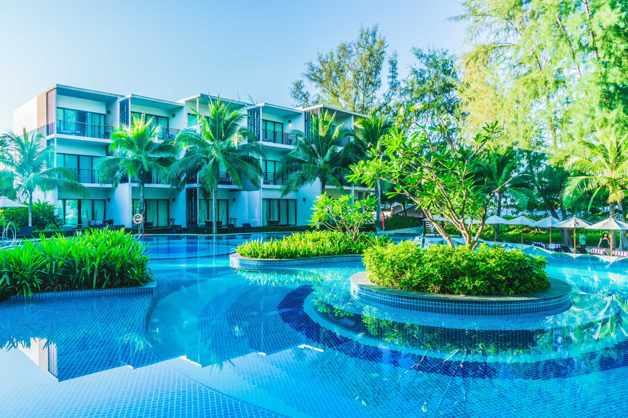 Umbrella and chair around hotel swimming pool resort - Filter effect processing